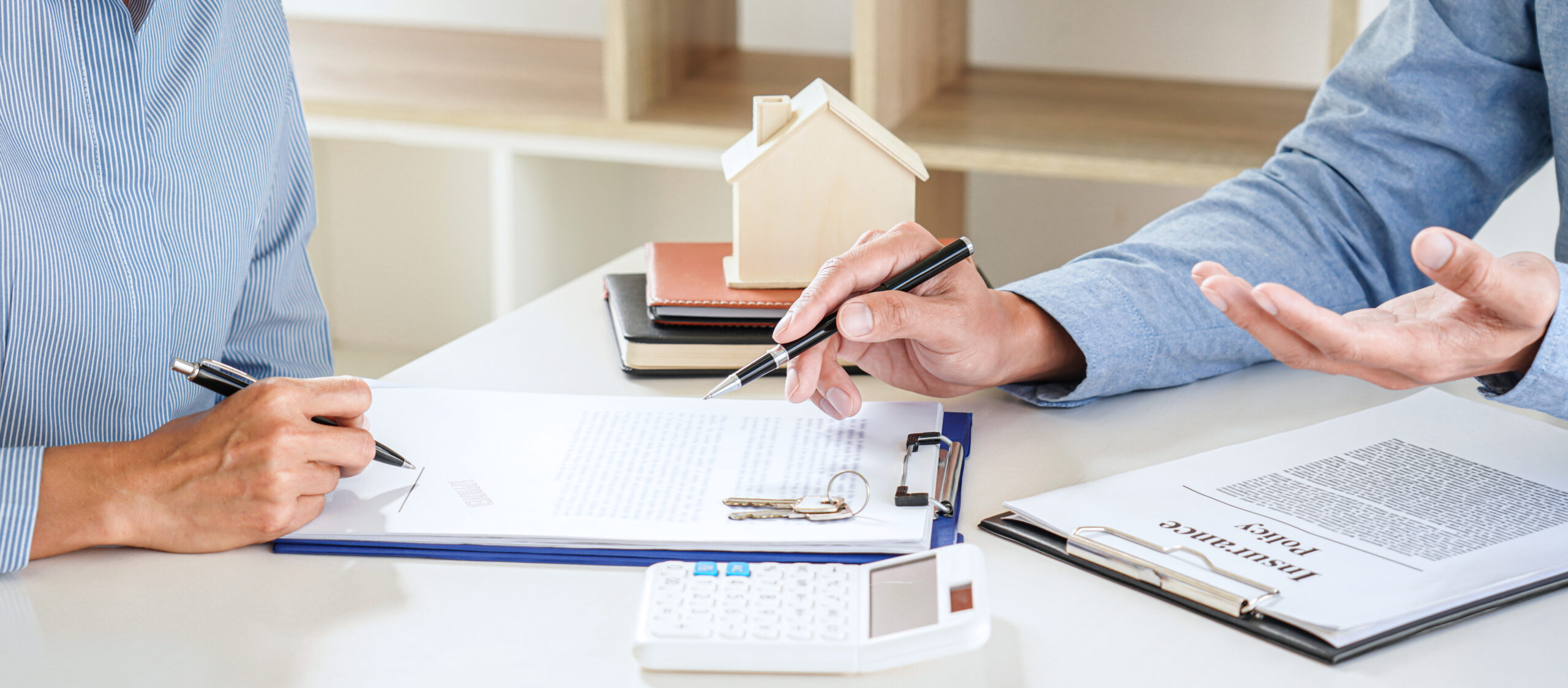 Real estate broker agent consult to customer to decision making sign insurance form and sending house model to client after approve, home model mortgage loan offer for and house insurance.